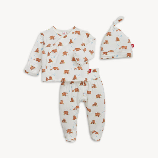Baby outfit set with long-sleeve shirt, pants, and hat featuring animal patterns on a white background.