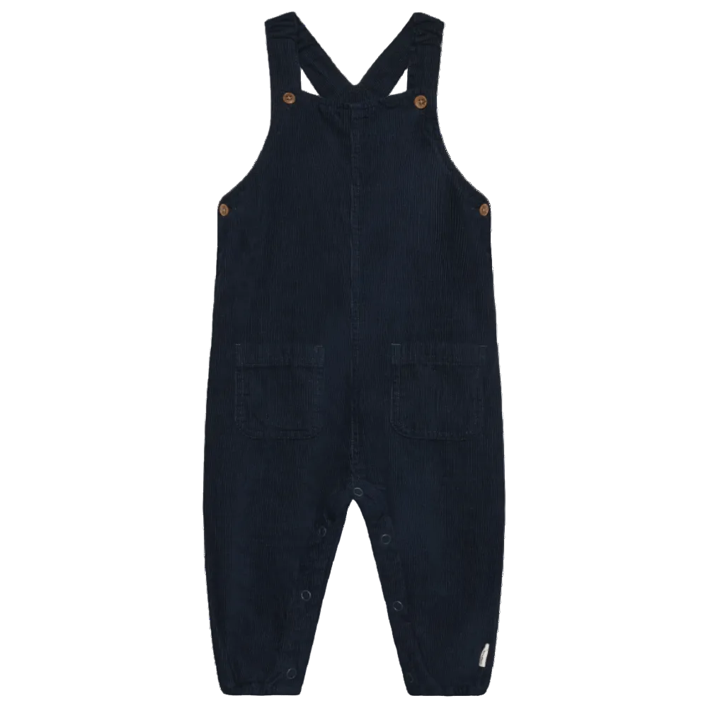 Black overalls with button closures on a white background