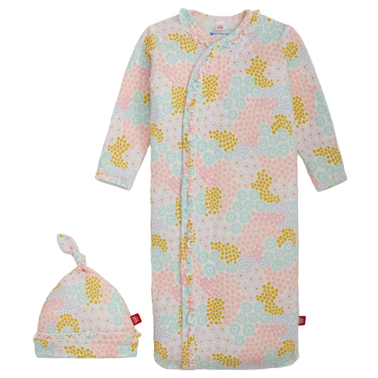 Baby onesie with yellow floral pattern and matching hat on a white background