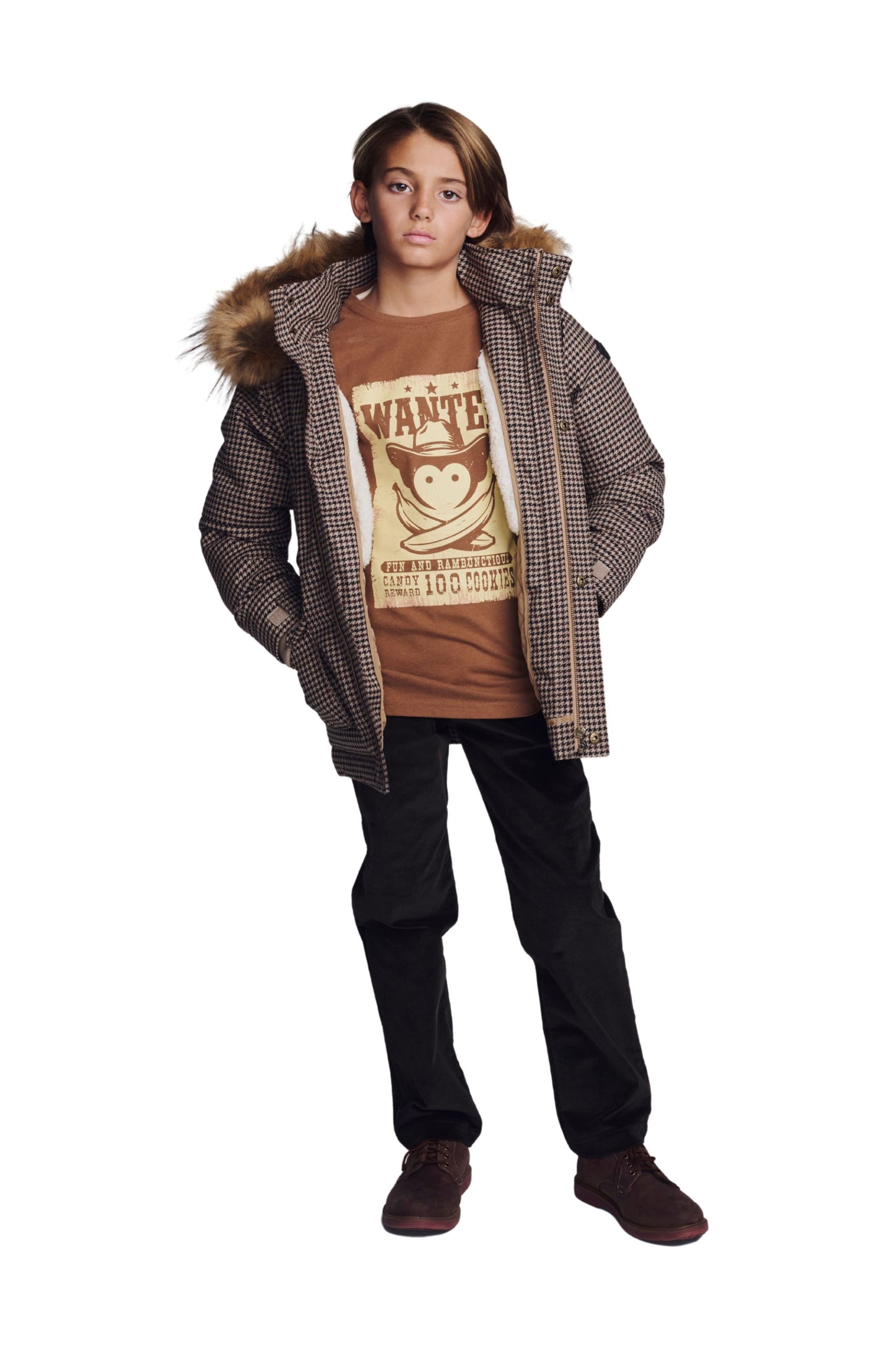 Boy wearing mocha graphic tee layered under a houndstooth winter coat