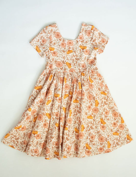 A floral print pink and orange short-sleeved dress with a full skirt, displayed against a white background.
