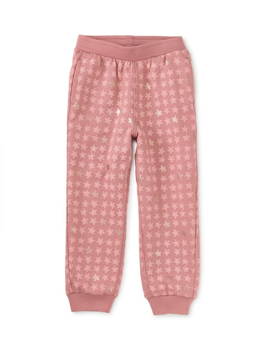 A pair of pink metallic stars joggers for girls, featuring an elastic waistband and fully functional interior drawcord.