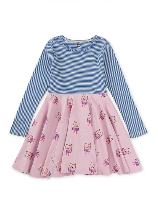 A long sleeve crew neck dress with a pink skirt featuring cat patterns and a blue top, designed for girls.