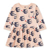 A long sleeve pink dress with a floral and bird pattern, featuring a wrap neckline and a below mid-thigh length.