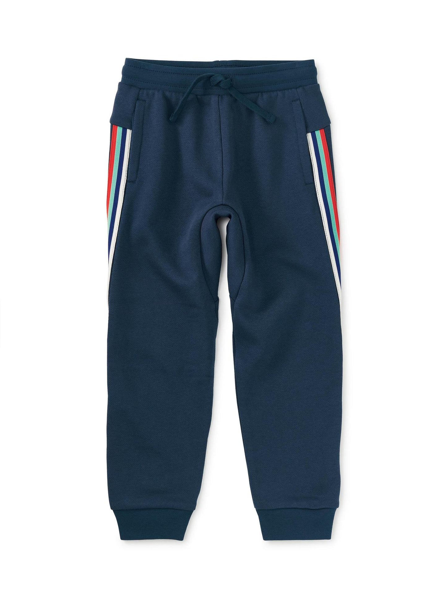 A pair of blue jogger pants for boys with contrasting white and red stripes on the legs and a drawstring waist.