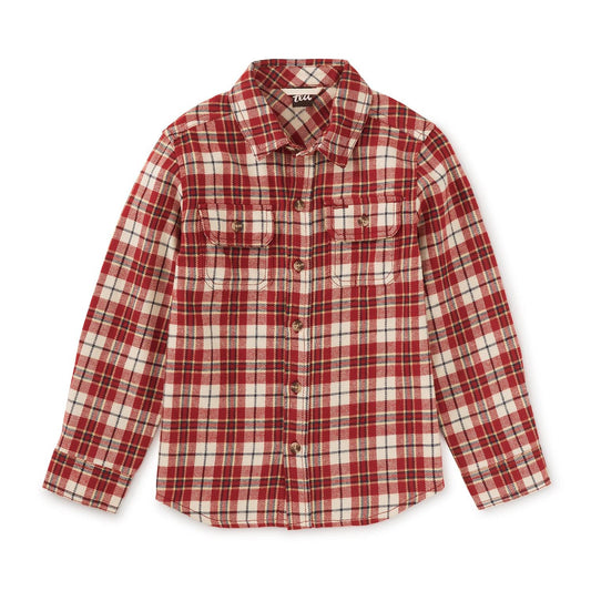 A brick red plaid flannel shirt with long sleeves, button closure, and patch pockets.
