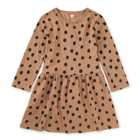 Brown dress with black polka dots on a white background