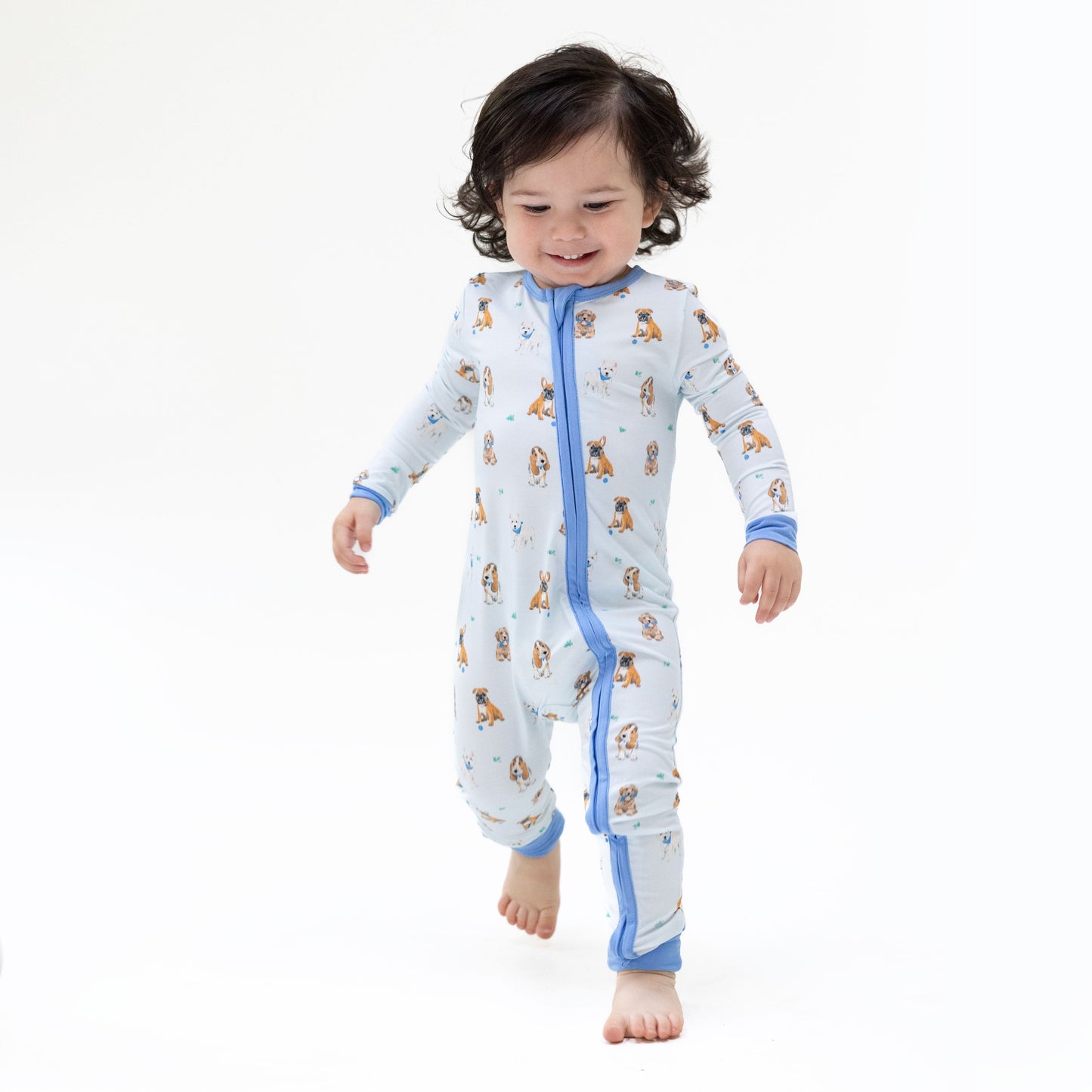 Baby wearing Angel Dear Besties Dogs Flip Romper in blue, lifestyle photo