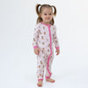 Baby wearing Angel Dear Besties Dogs Flip Romper in pink, lifestyle photo