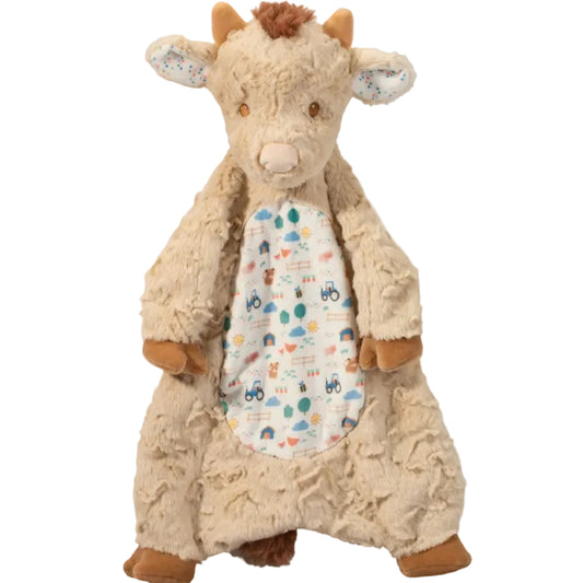 Plush toy cow with a patterned body on a white background
