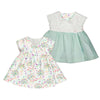 Reversible baby's dress, one floral and one solid color, on a white background.