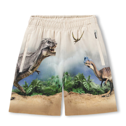 Dinosaur-themed shorts with a prehistoric landscape design on a beige background