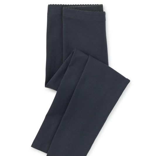 Pair of dark blue leggings on a white background