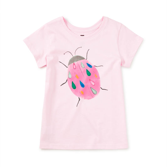 Pink t-shirt with a ladybug design on a white background