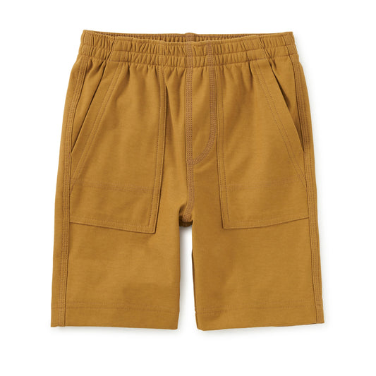 Mustard yellow shorts with an elastic waistband on a white background