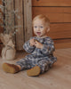 Winter plaid baby romper with coconut buttons down the front