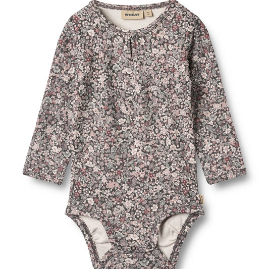 Floral patterned baby bodysuit on a white background