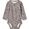 Floral patterned baby bodysuit on a white background