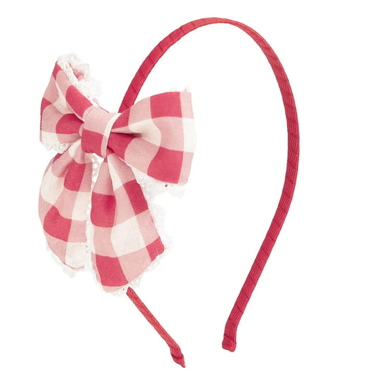Red and white checkered bow headband on a white background