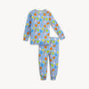A two-piece baby pajama set featuring a long-sleeve top and matching pants in light blue, covered in an all-over baseball-themed print with balls, bats, and fielding accessories in orange, yellow, green, white, and blue.