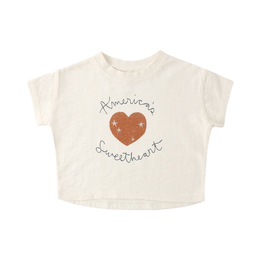 Beige t-shirt with 'America's Sweetheart' design on a white background