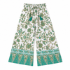 Floral-patterned pants with green accents on a white background