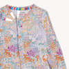A close up of a baby long-sleeve one-piece romper with an all-over colorful floral and butterfly pattern on a light pink base.