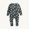 A baby long-sleeve one-piece coverall with an all-over dinosaur space print on a black background, shown against a light off-white background.
