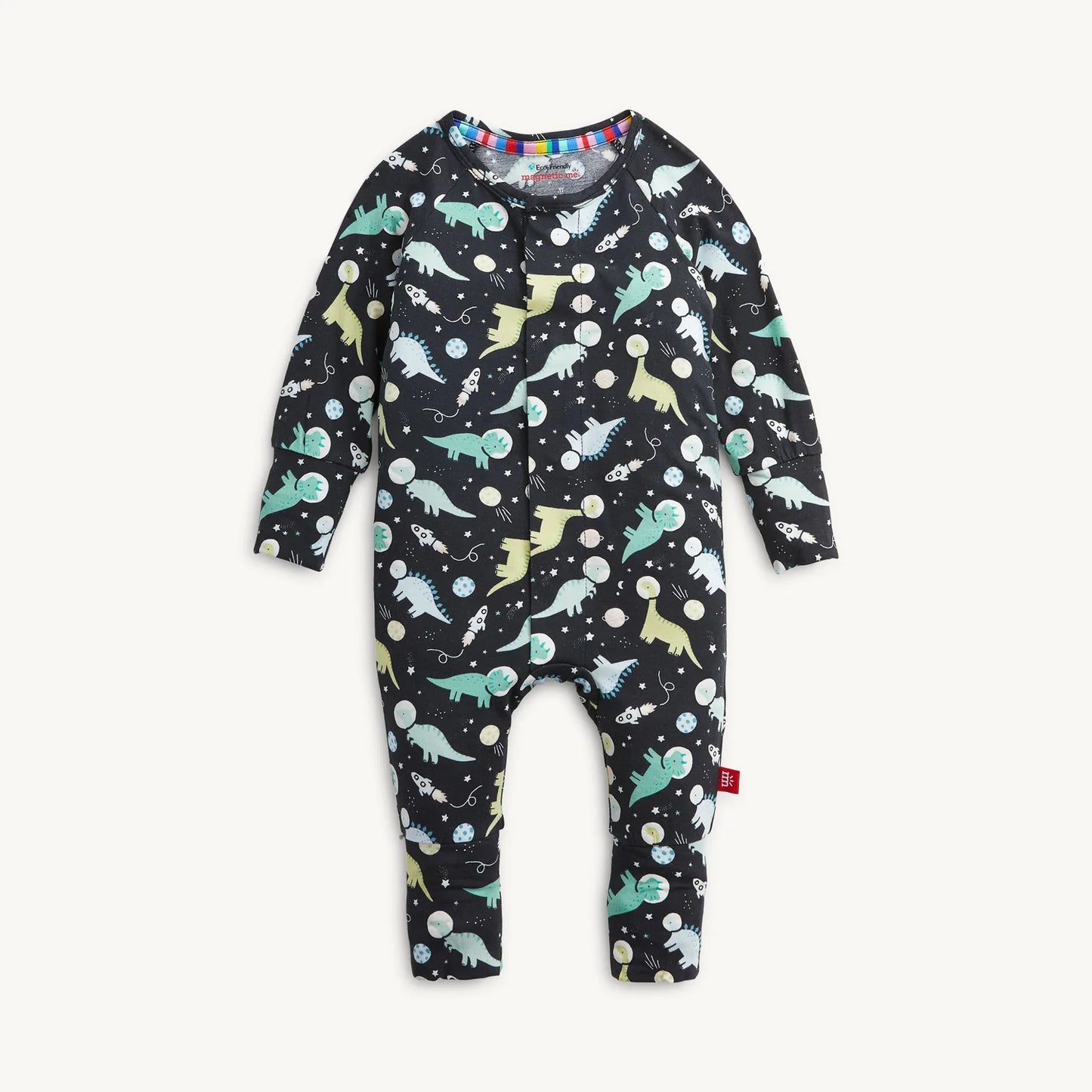 A baby long-sleeve with convertible footies one-piece pajama with an all-over dinosaur print on a black background, shown flat against a light off-white background.