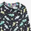 A close up of the top of a children's pajama set featuring an all-over dinosaur space print on a dark nav blue primary color.