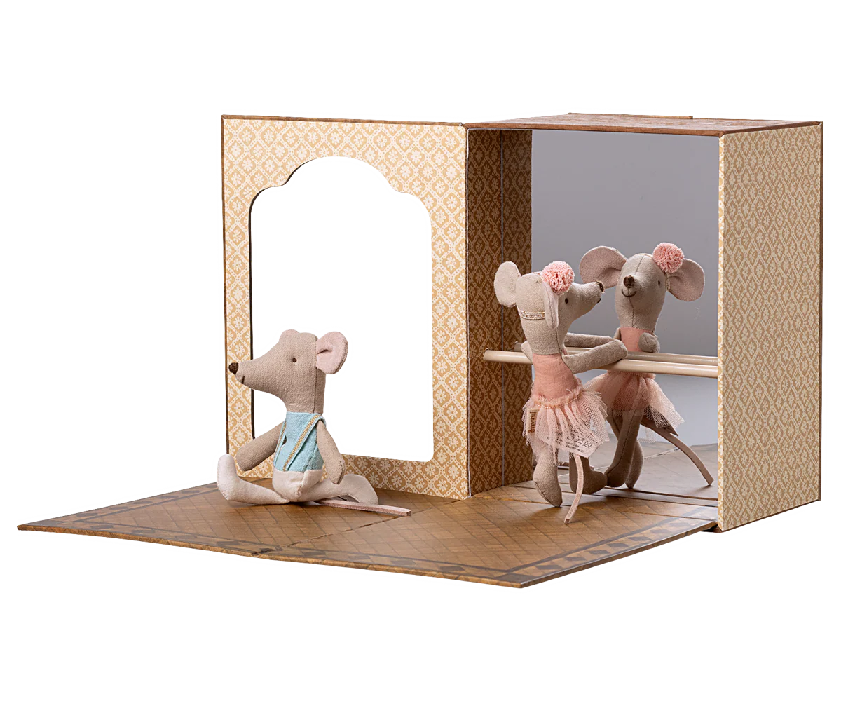 Toy mouse figures in a display case with a white background
