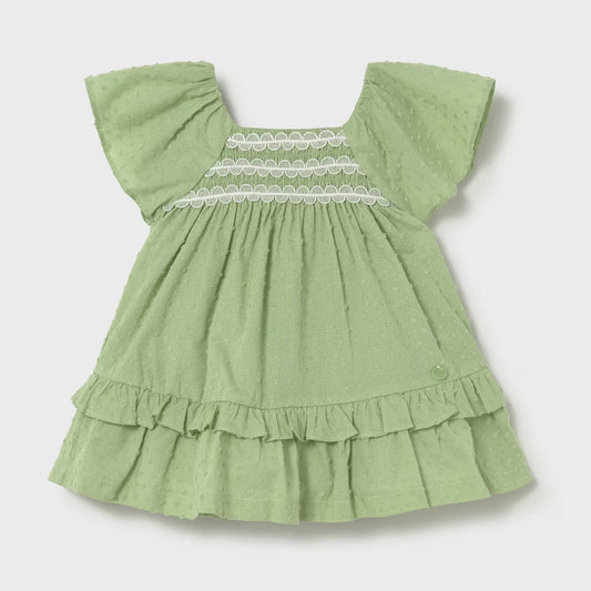 Green swiss dot dress with lace detail across chest. 