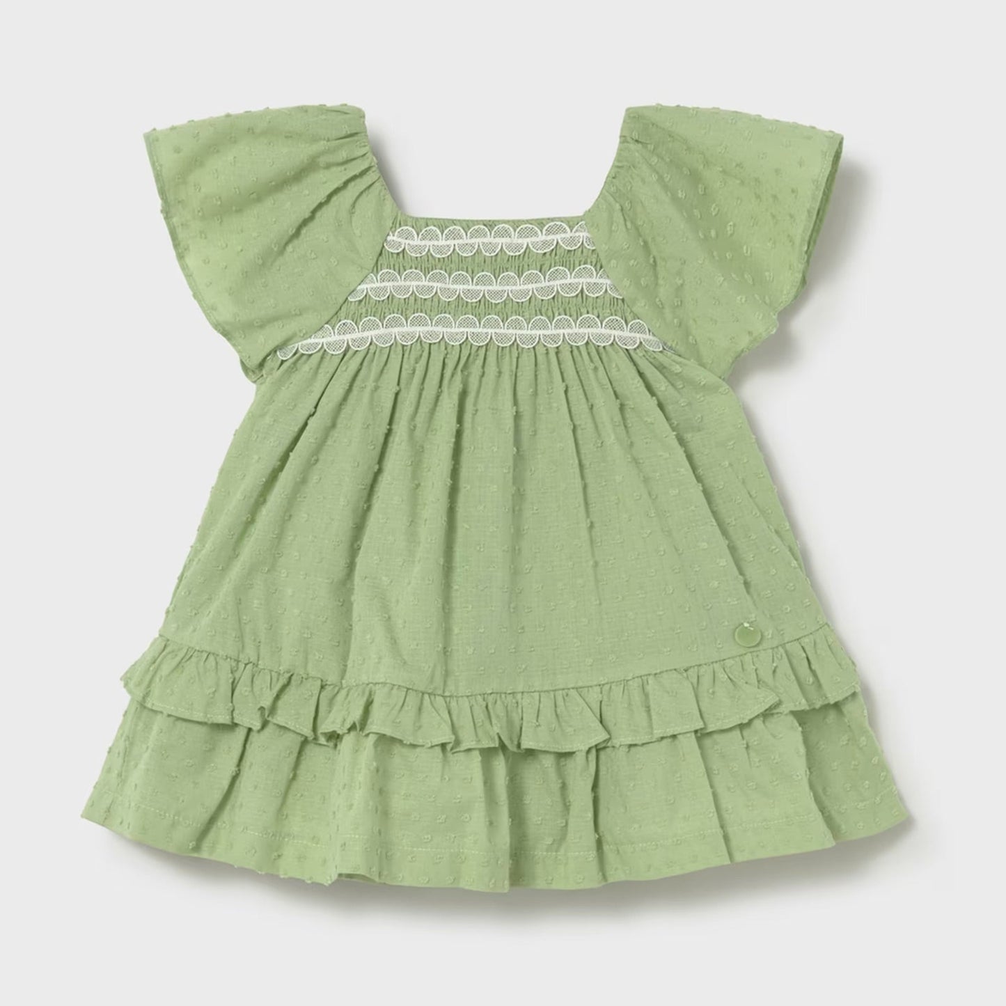 Green swiss dot dress with lace detail across chest. 