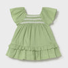Green swiss dot dress with lace detail across chest. 