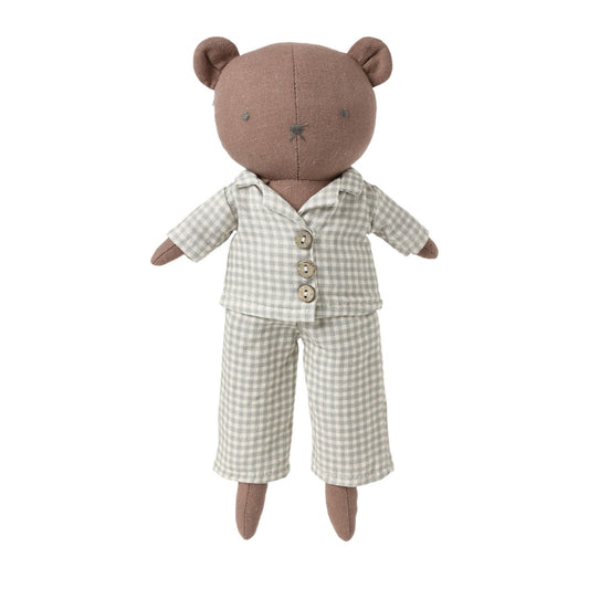 A plush teddy bear doll wearing a beige and white gingham pajama set, photographed against a solid light gray background.