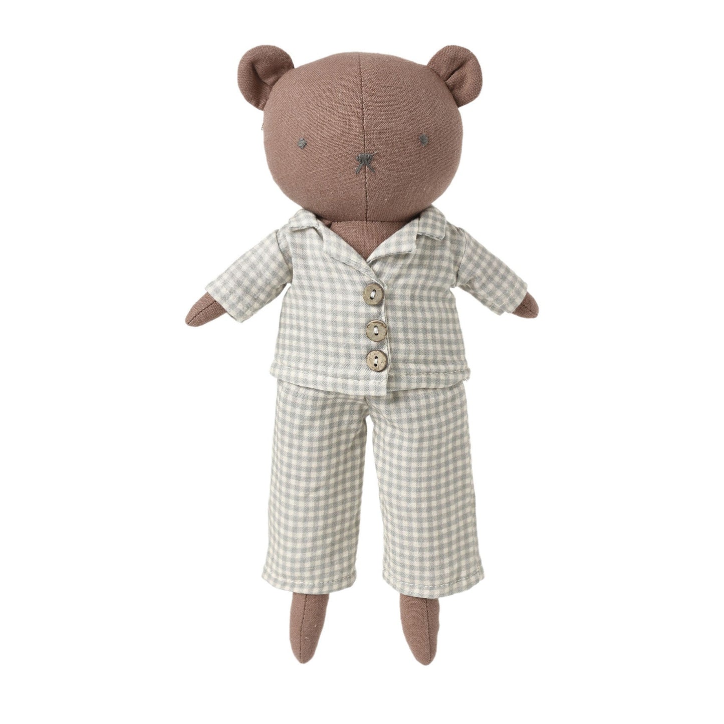 A plush teddy bear doll wearing a beige and white gingham pajama set, photographed against a solid light gray background.
