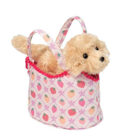 Small dog inside a pink patterned bag on a white background