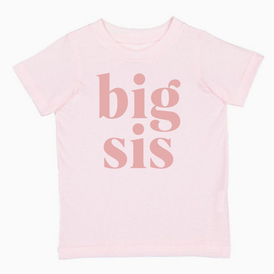 A dusty rose colored t-shirt with the white text 'BIG SIS' printed on the front.