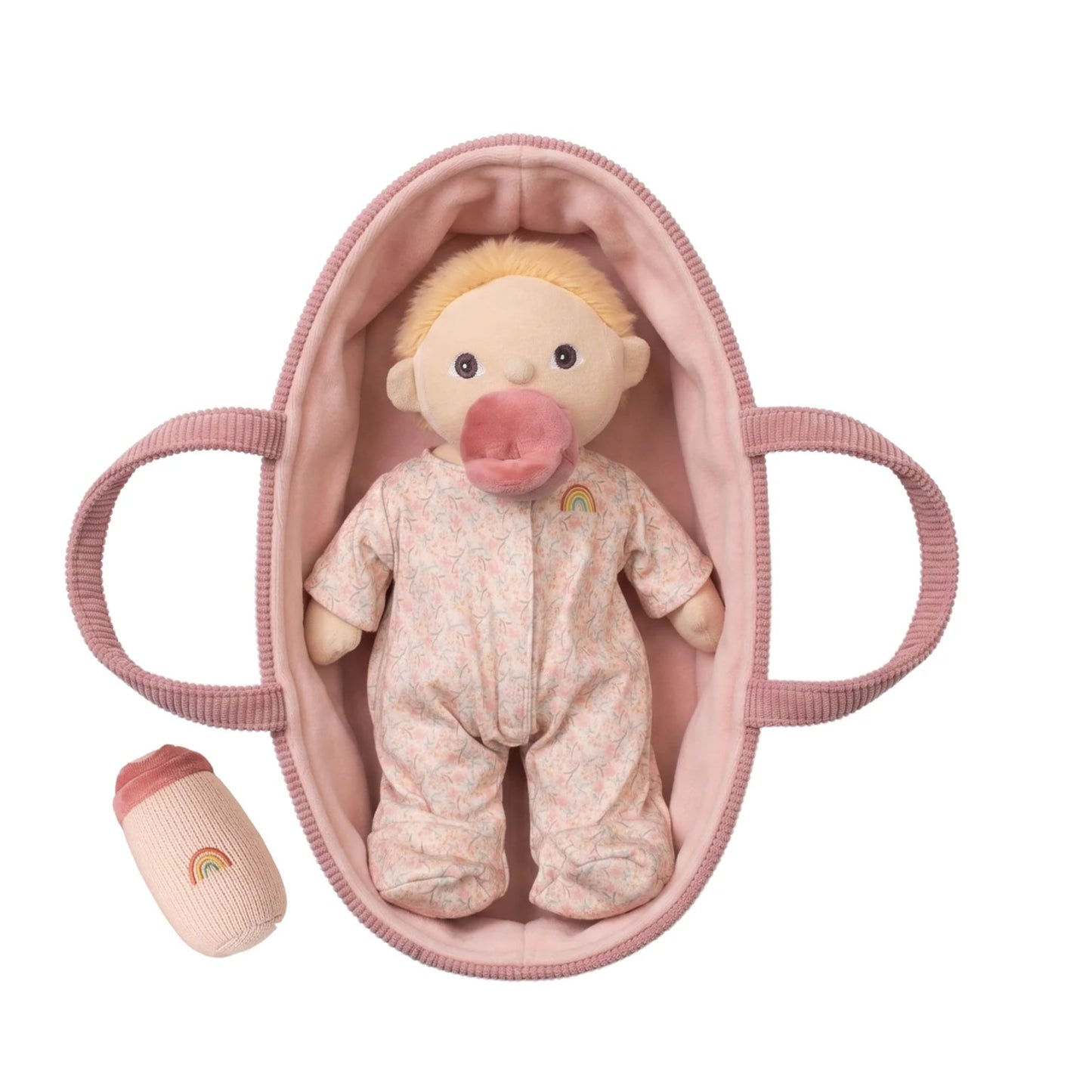 Baby doll in a pink crib with a pacifier on a white background