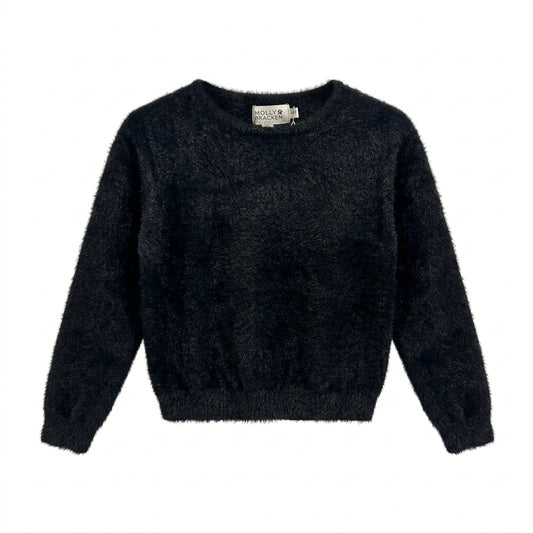 A black fuzzy long-sleeve cropped sweater hanging on a white hanger against a white wall.