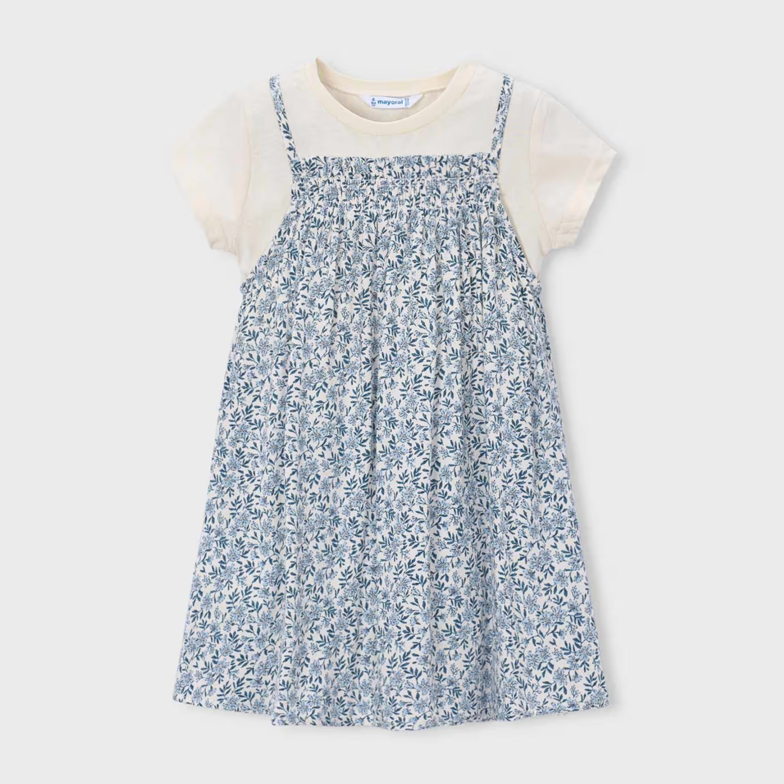 Children's dress with blue floral pattern layered over a white tee