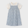 Children's dress with blue floral pattern layered over a white tee