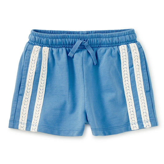 Blue shorts with lace trim on a white background