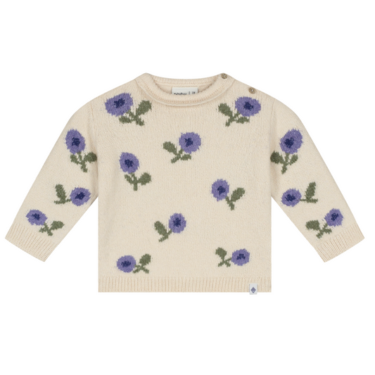 A cream-colored knit sweater with an all-over pattern of purple flowers and green leaves, displayed flat against a solid white background.