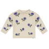A cream-colored knit sweater with an all-over pattern of purple flowers and green leaves, displayed flat against a solid white background.