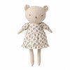 A plush teddy bear doll wearing a cream-colored dress with a small brown floral pattern, set against a plain white background.