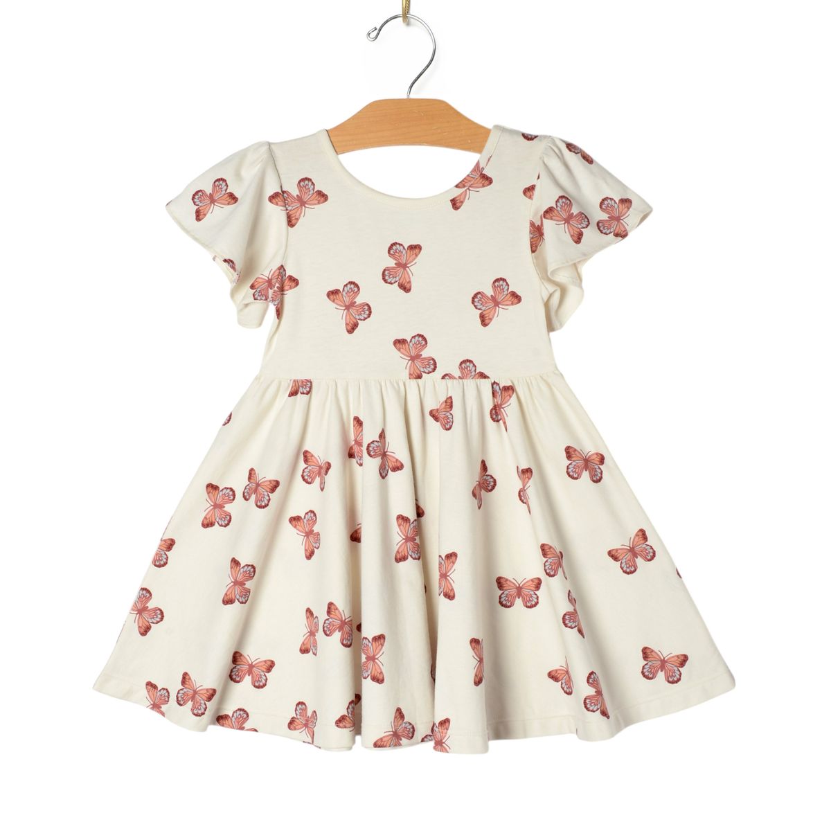 White dress with pink butterfly pattern on a hanger 