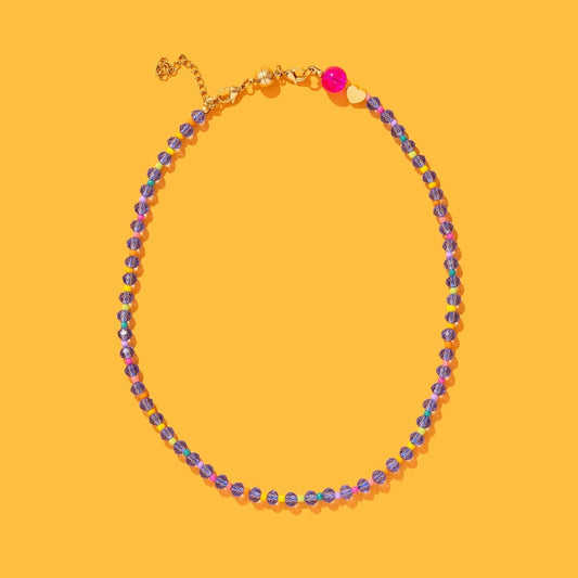 Necklace with multicolored beads on a yellow background