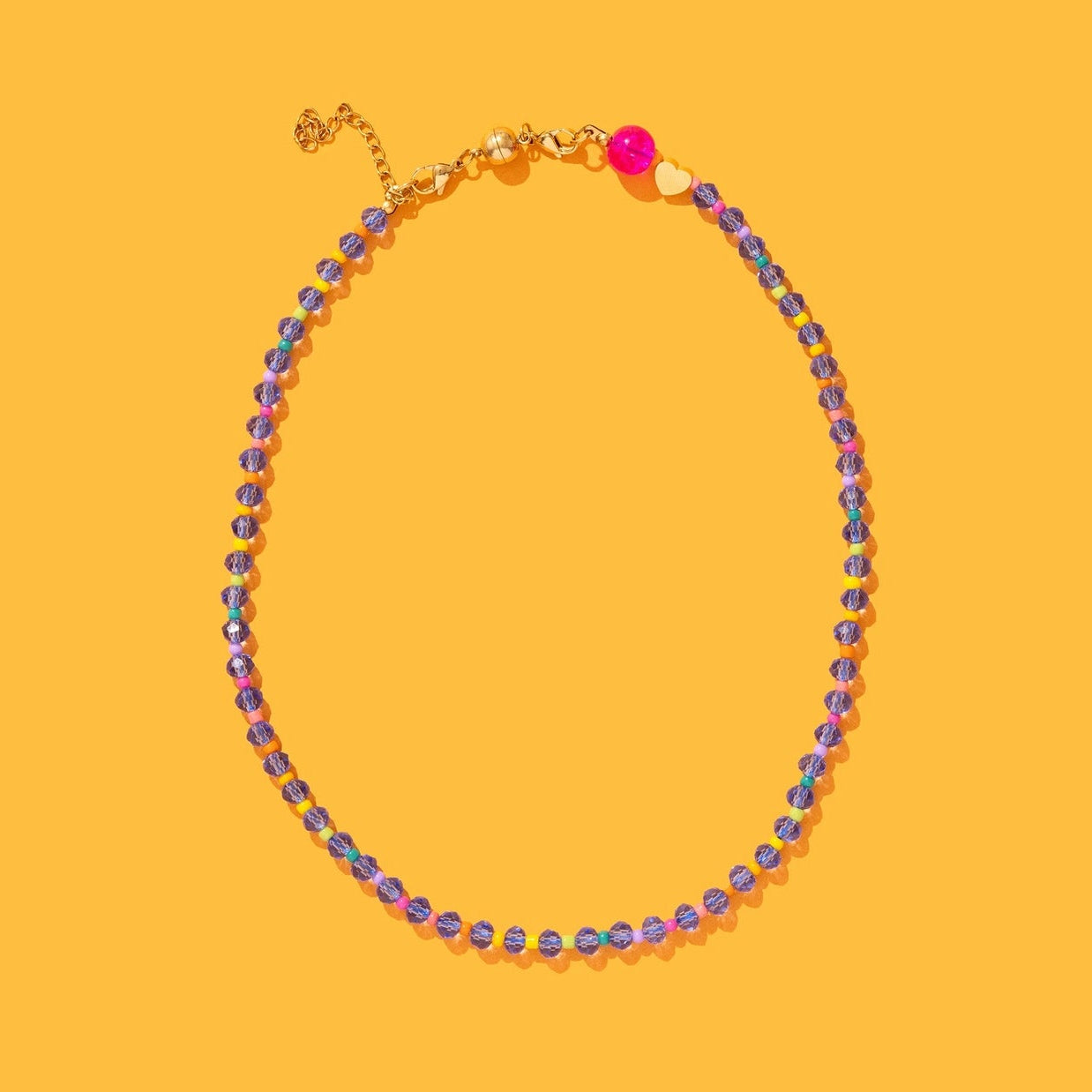 Necklace with multicolored beads on a yellow background