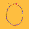Necklace with multicolored beads on a yellow background